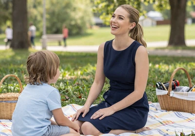Woman doctor enjoying a family picnic in a green park on a sunny day