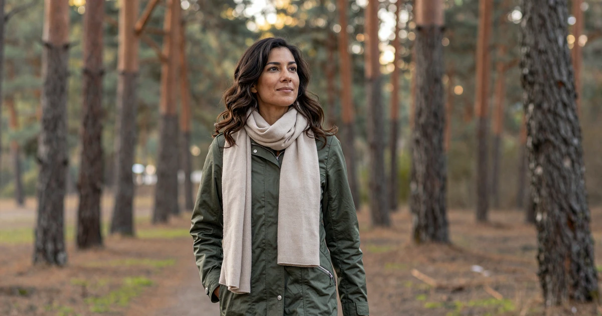 Female pulmonologist walking through a pine forest on a crisp morning