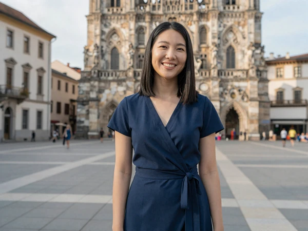 Female travel nurse smiling in a new city square on her day off