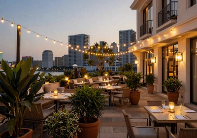 Upscale restaurant terrace at twilight with warm string lights
