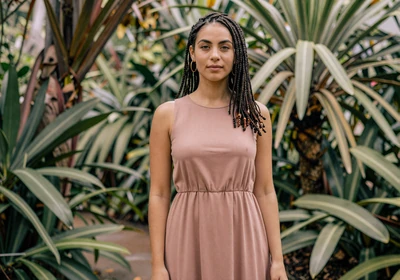 Woman doctor standing among tropical plants in a botanical garden