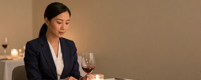 Female ICU nurse enjoying a quiet dinner at an upscale restaurant