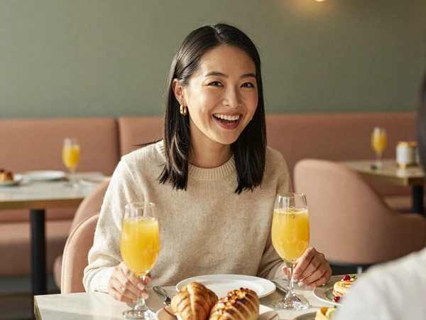 Anesthesiologist enjoying a relaxed weekend brunch in a warm restaurant